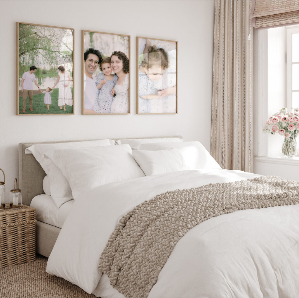 Bedroom with neutral colors featuring framed Carmel family pictures hanging above the bed