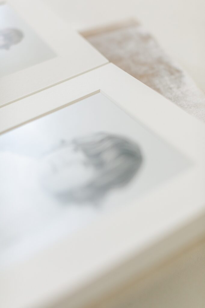 An heirloom matted album open to a black and white image of a young boy, Family photography in Carmel