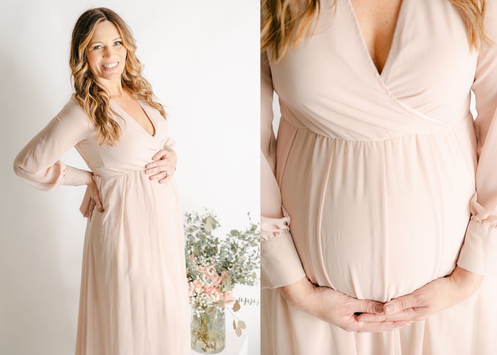 mother holding baby bump  wearing a blush dress at her Avon maternity photography session 