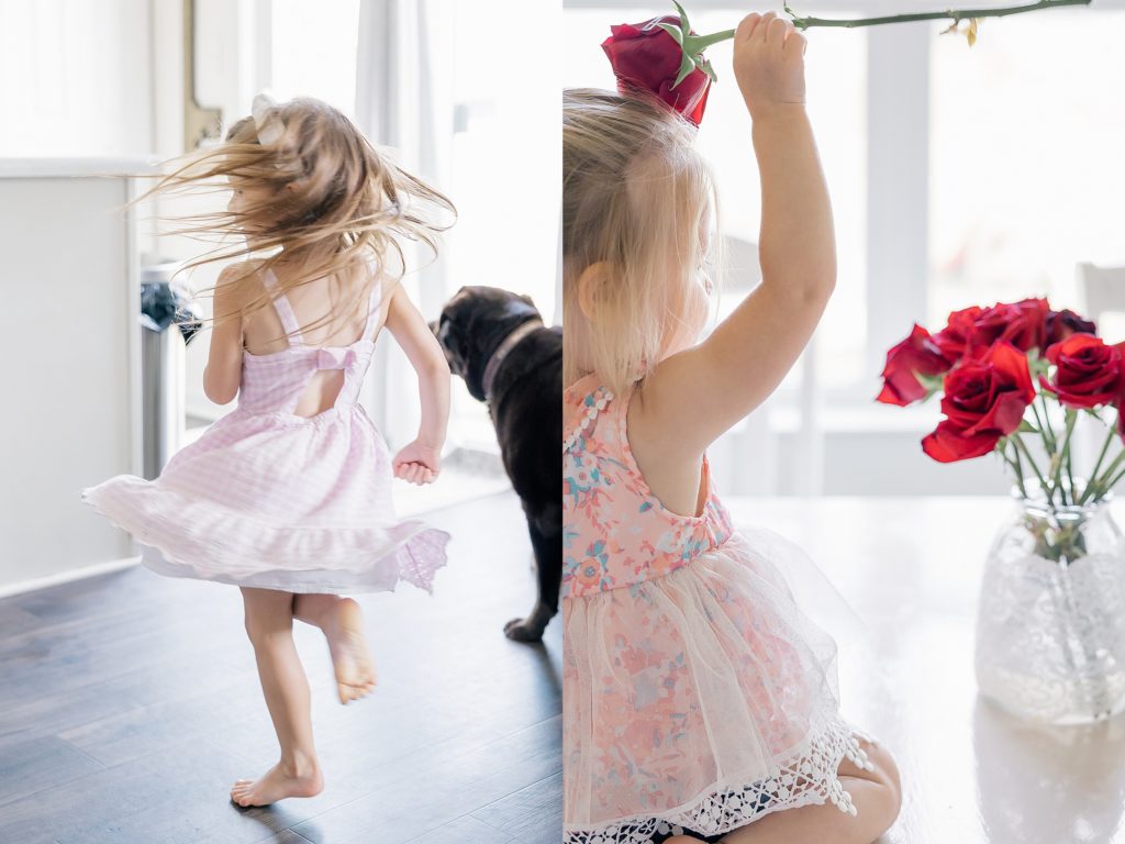 Indianapolis lifestyle family photography session girl in pink dress twirling in kitchen and a toddler girl playing with roses on the dining room table