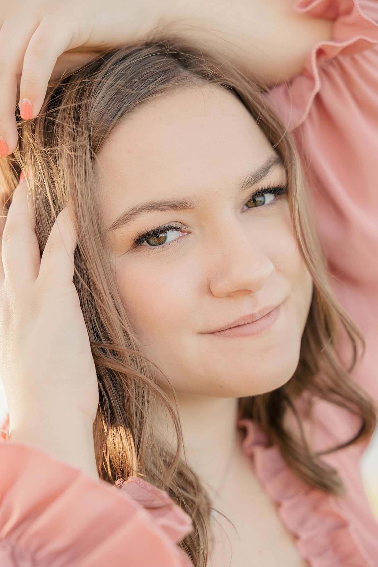 close up of senior girl in pink dress at her senior photography session with Carmel senior photographer Brittney Lear Photography