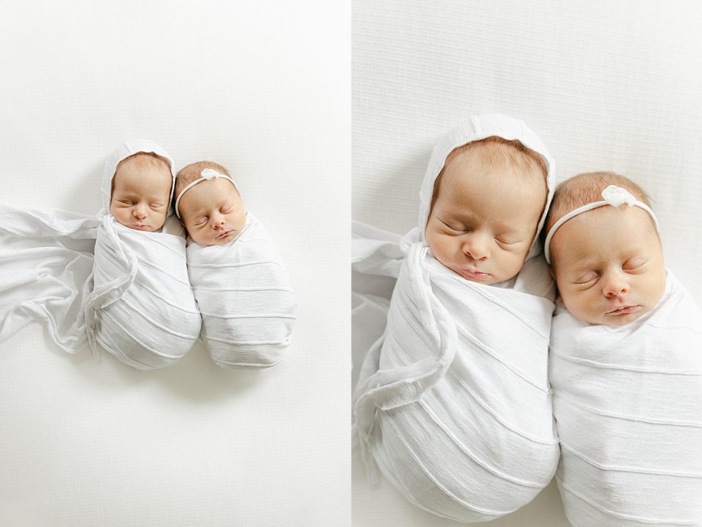 Newborn twins sleeping swaddled in white laying on a white blanket with their heads together Carmel newborn photographer