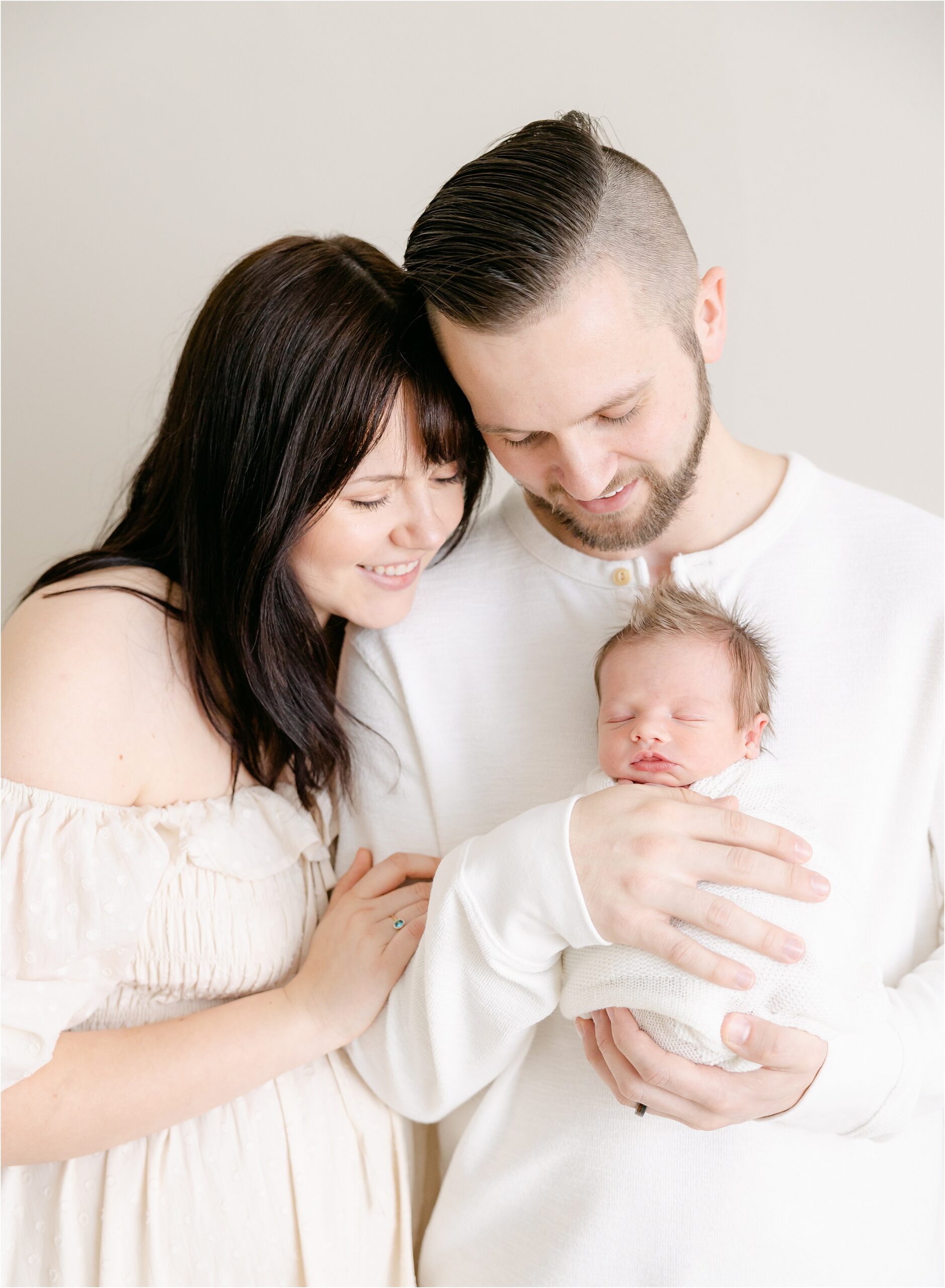 Mother and father looking at newborn baby boy in an Indianapolis studio