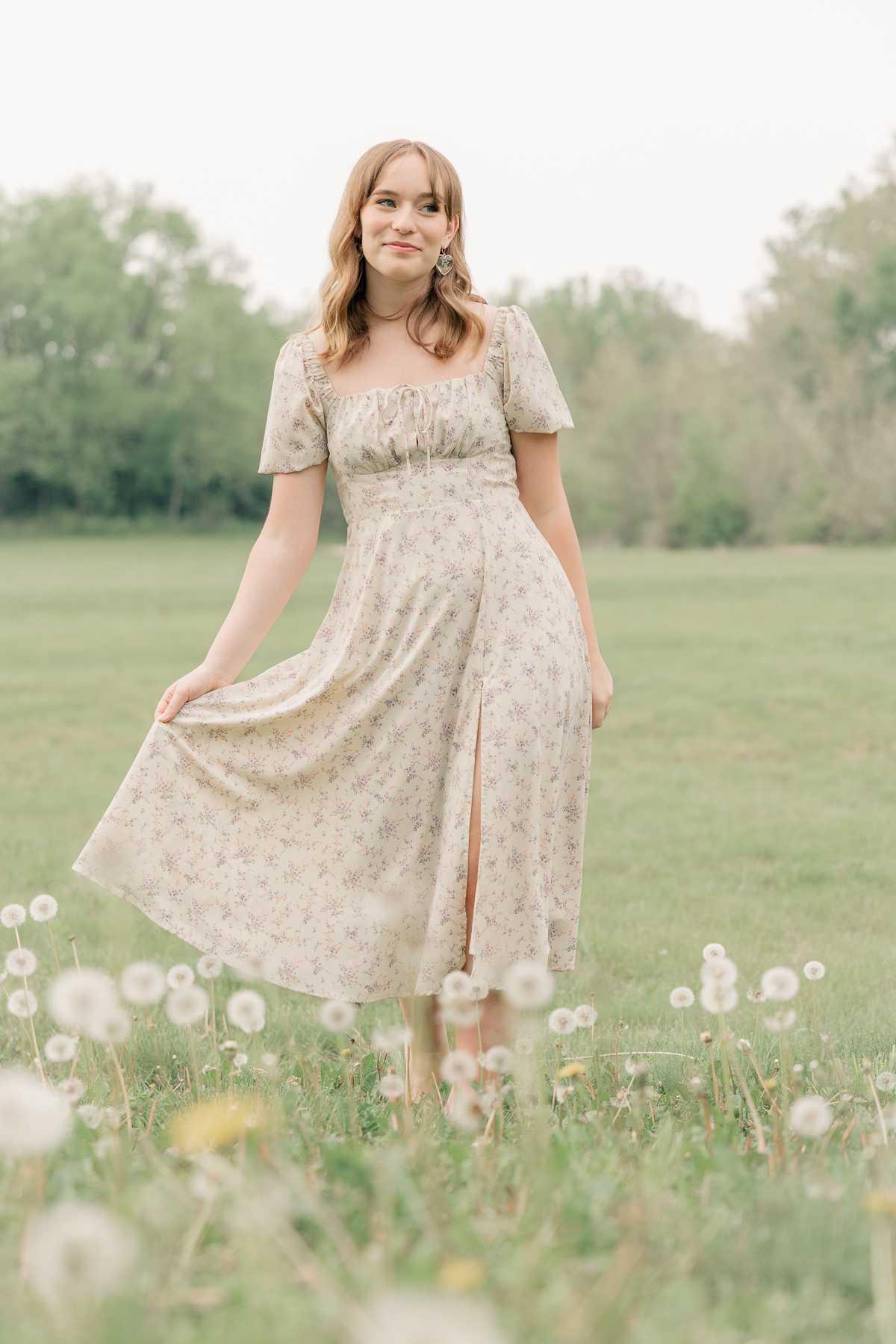 girl in long cream floral dress walks through field of dandelions, Plainfield senior photography