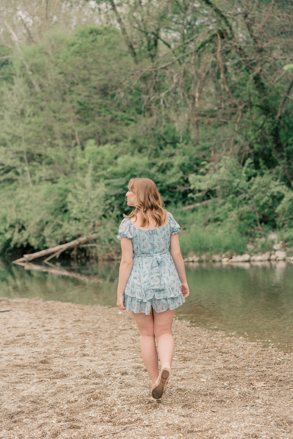 girl in blue floral dress walks by creek, Plainfield senior photography
