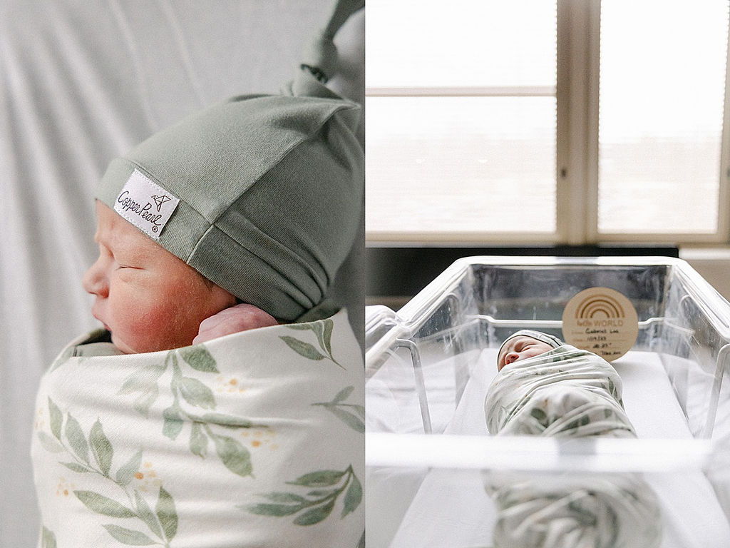 A newborn baby sleeps in a hospital crib wearing a green sleep cap and matching swaddle postpartum doula indianapolis