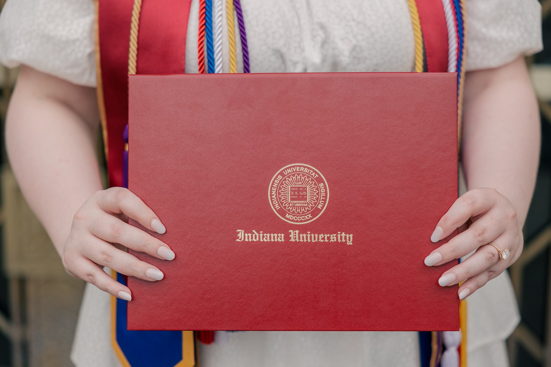 close up of woman holding college diploma 
