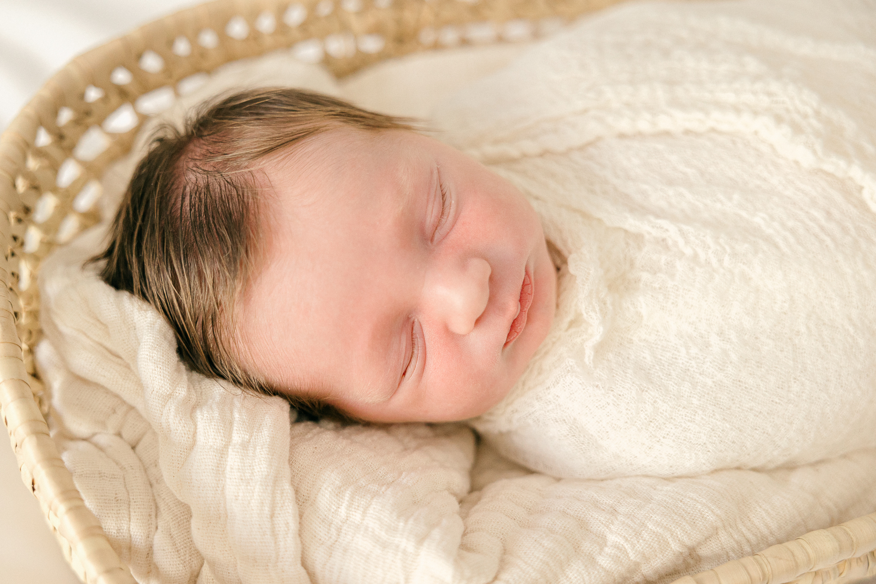 newborn baby swaddled in cream in a moses basket, Indianapolis Photographer