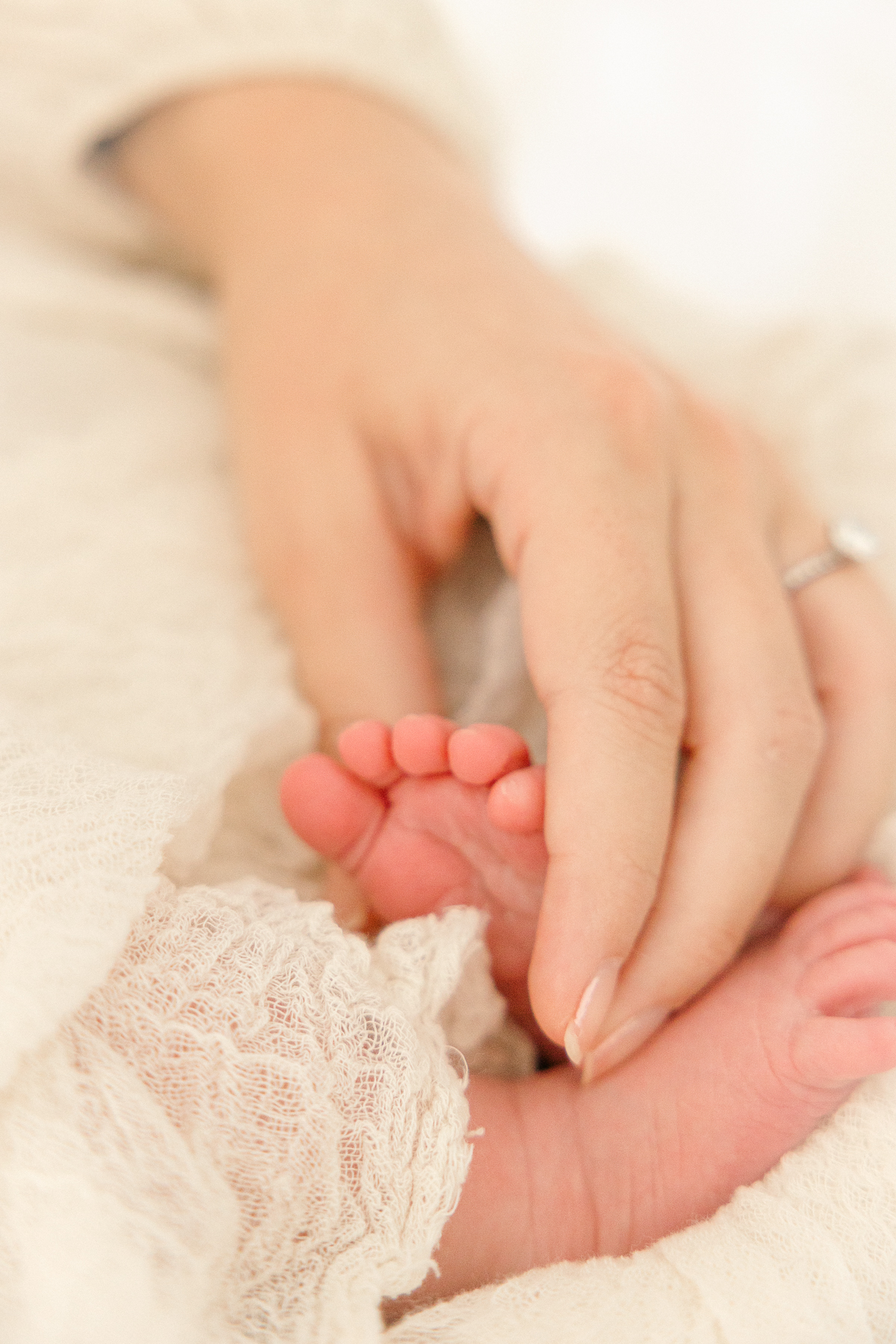 close up of mother's hand holding newborn baby's foot, Indianapolis Photographer